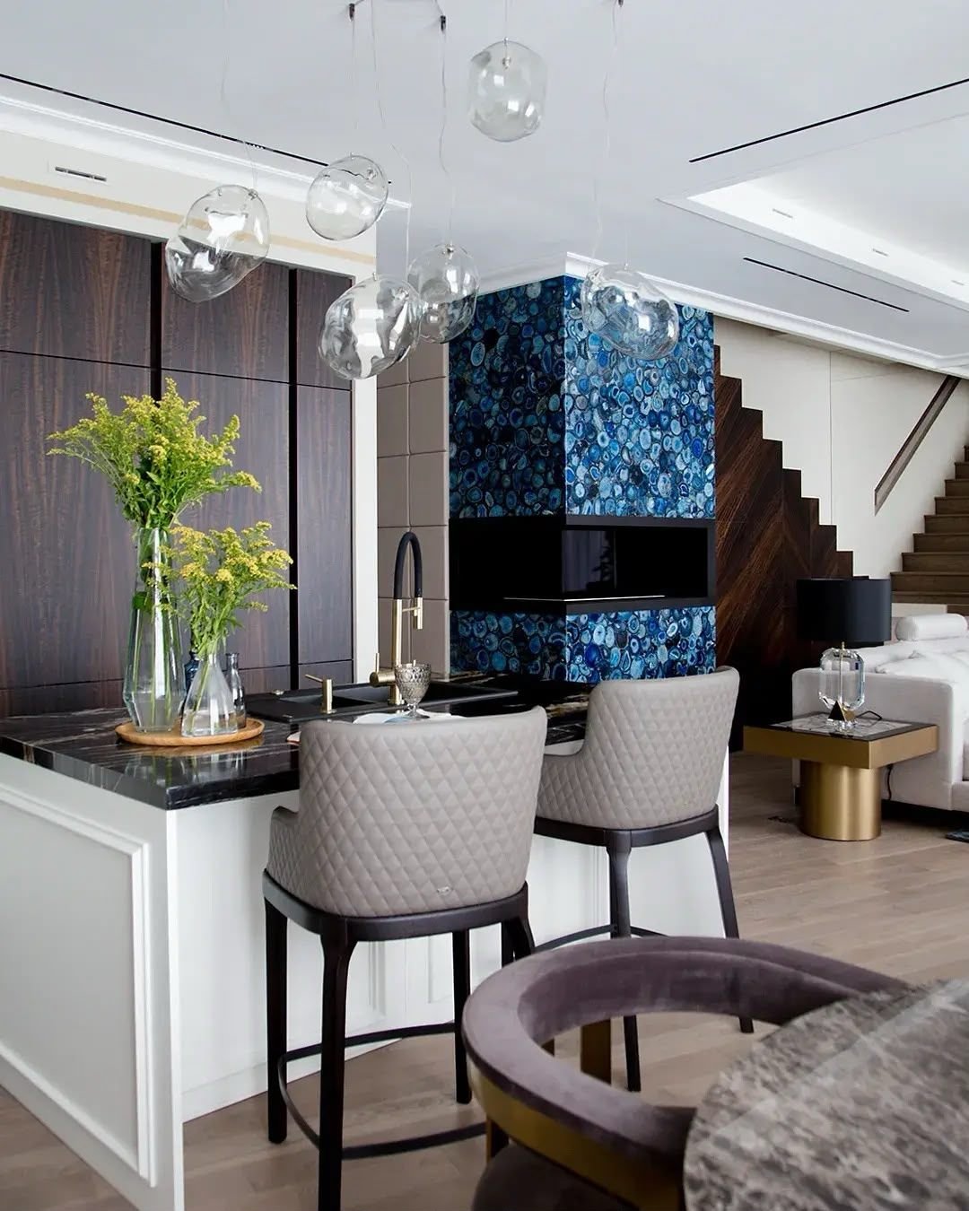 Blue agate media wall beside a kitchen in an open-plan living area, Dubai
