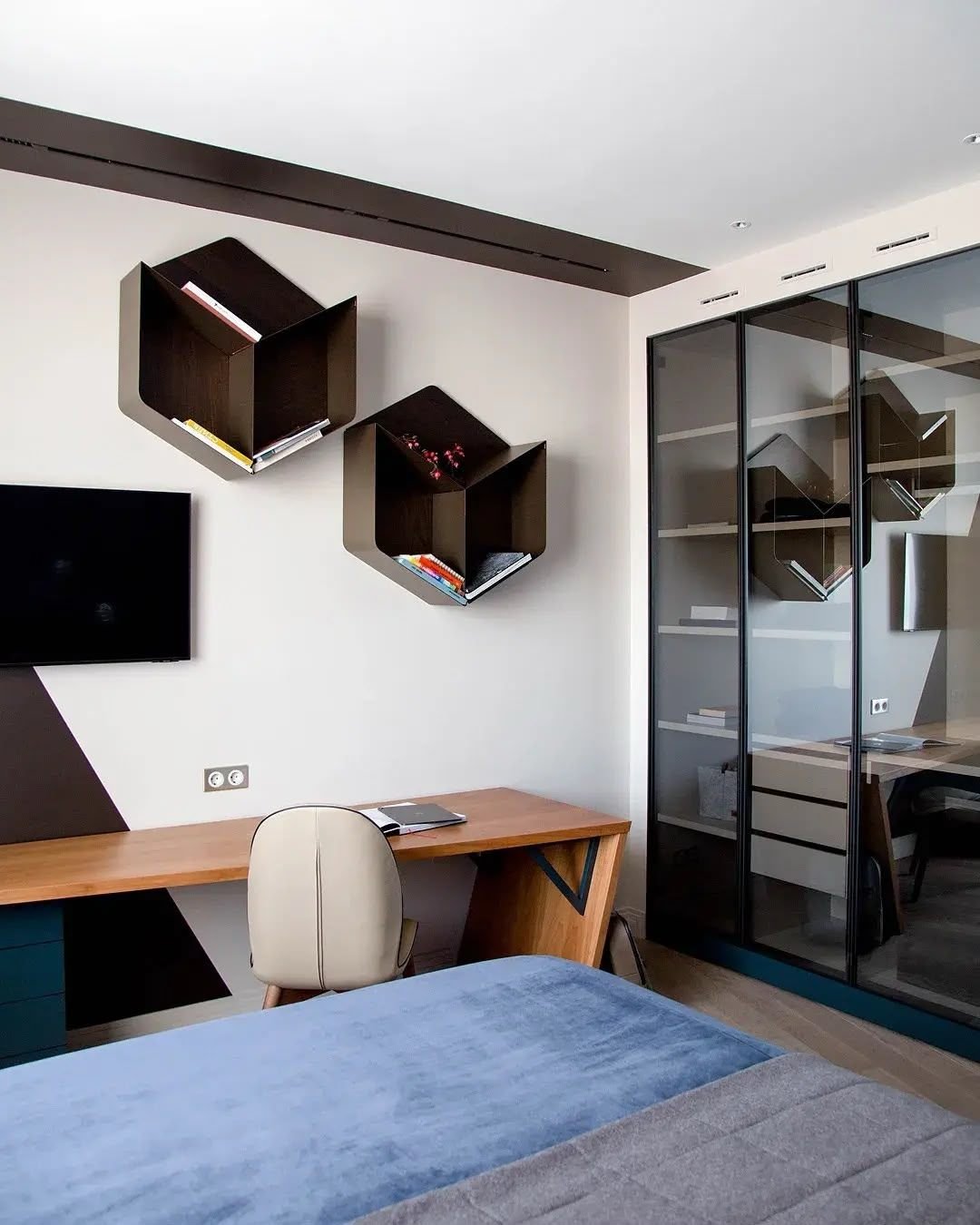 Blue bedroom with glass-fronted fitted wardrobe and study, Dubai