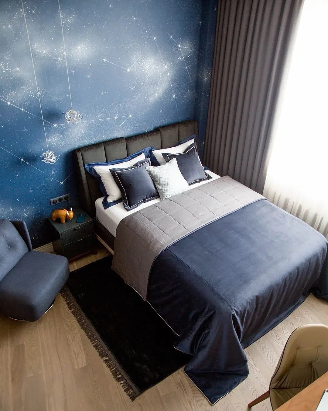 Blue bedroom with fitted joinery and starry feature wall, Dubai