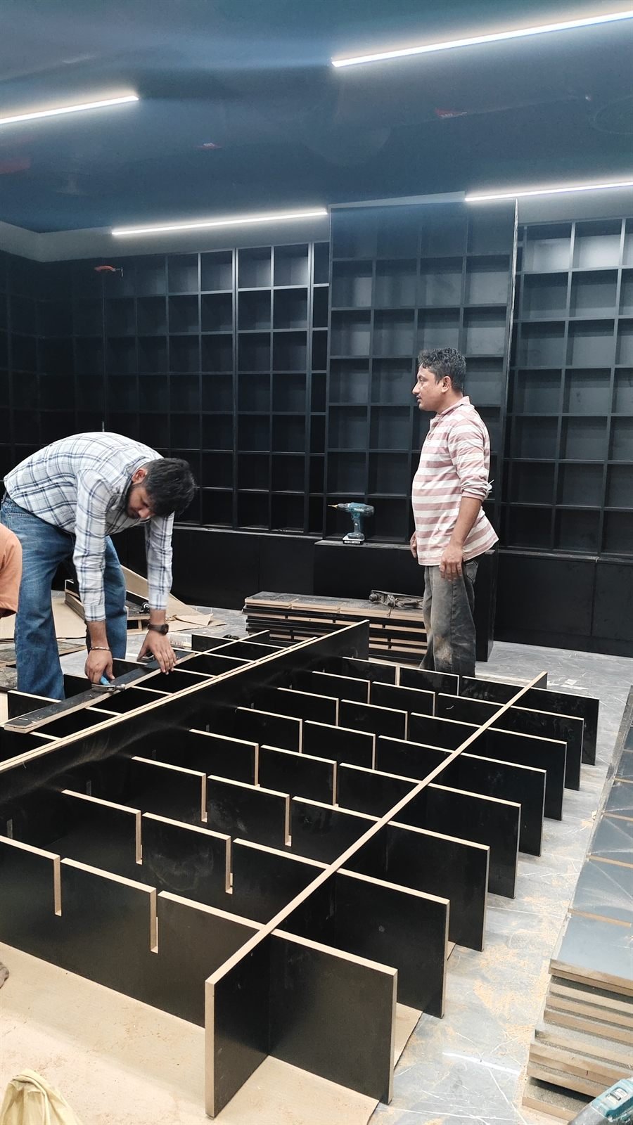Carpenters assembling a display island on site, Dubai