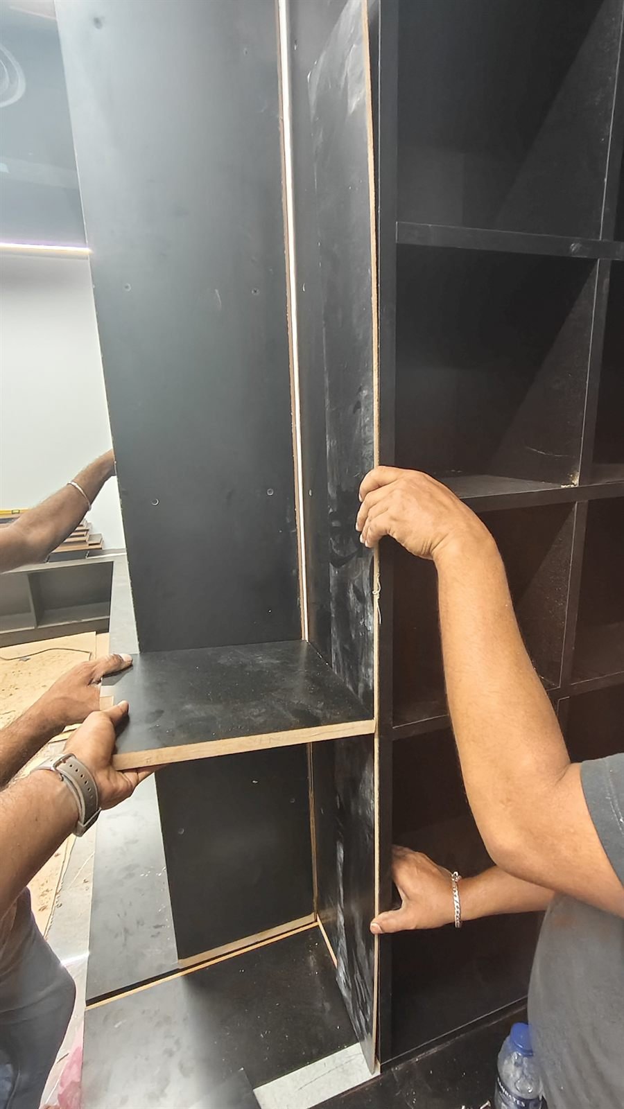 Close-up of black shelving installation detail, Dubai