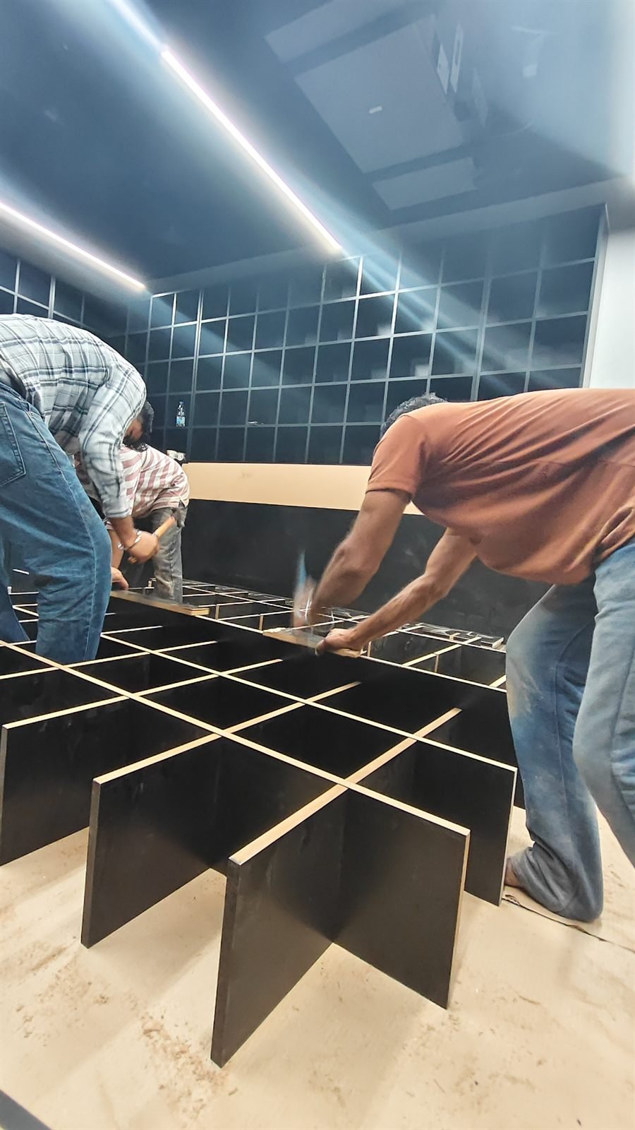 Custom display island grid assembly on site, Dubai