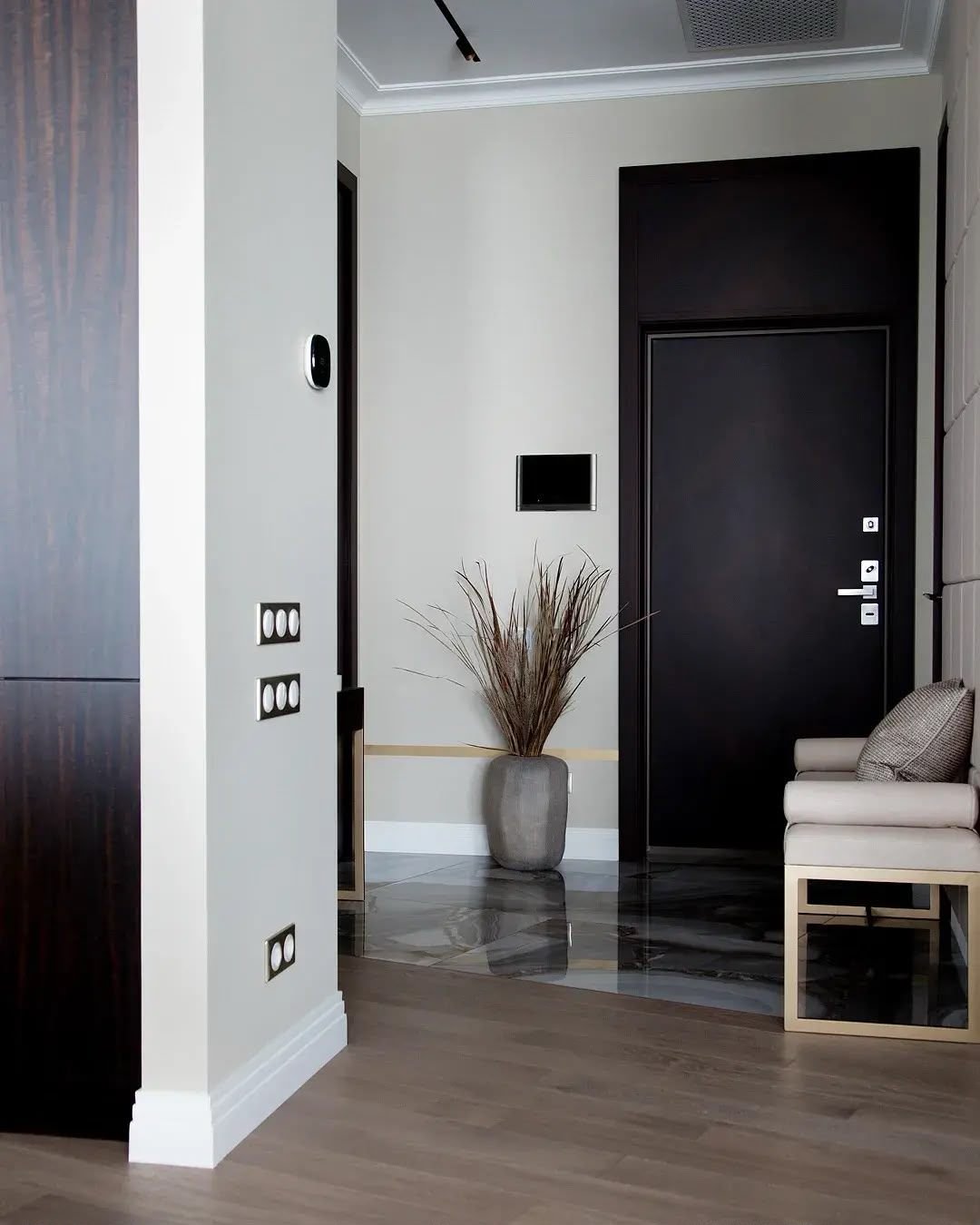 Entrance hall joinery around a black door, Dubai