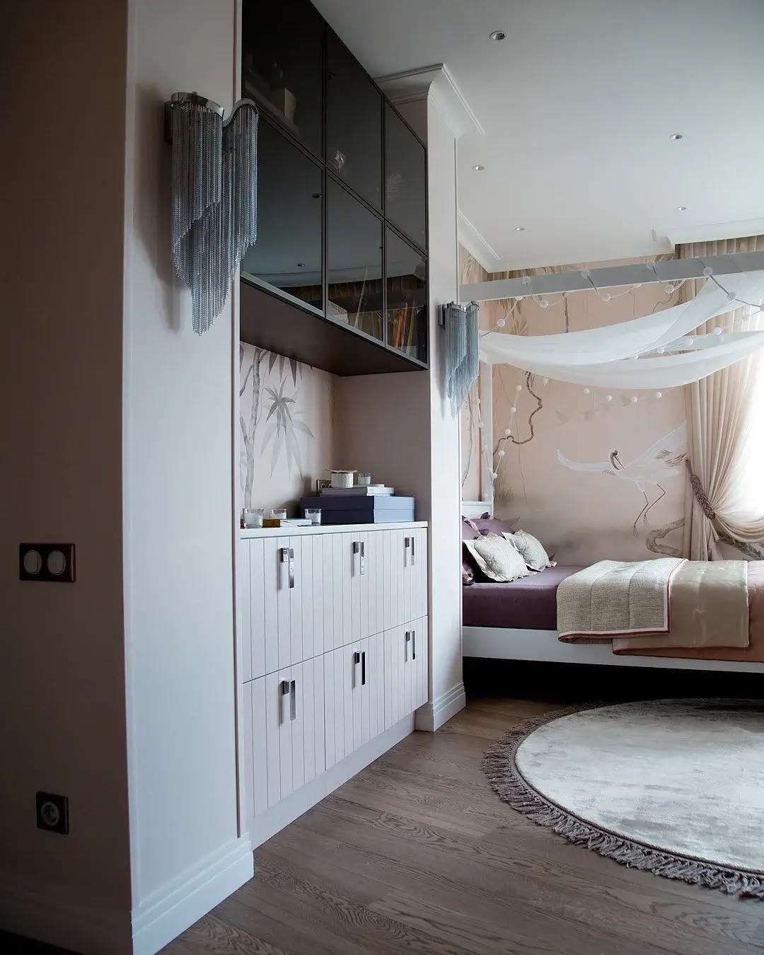 Girl's bedroom with fitted wardrobe run and canopy bed, Dubai