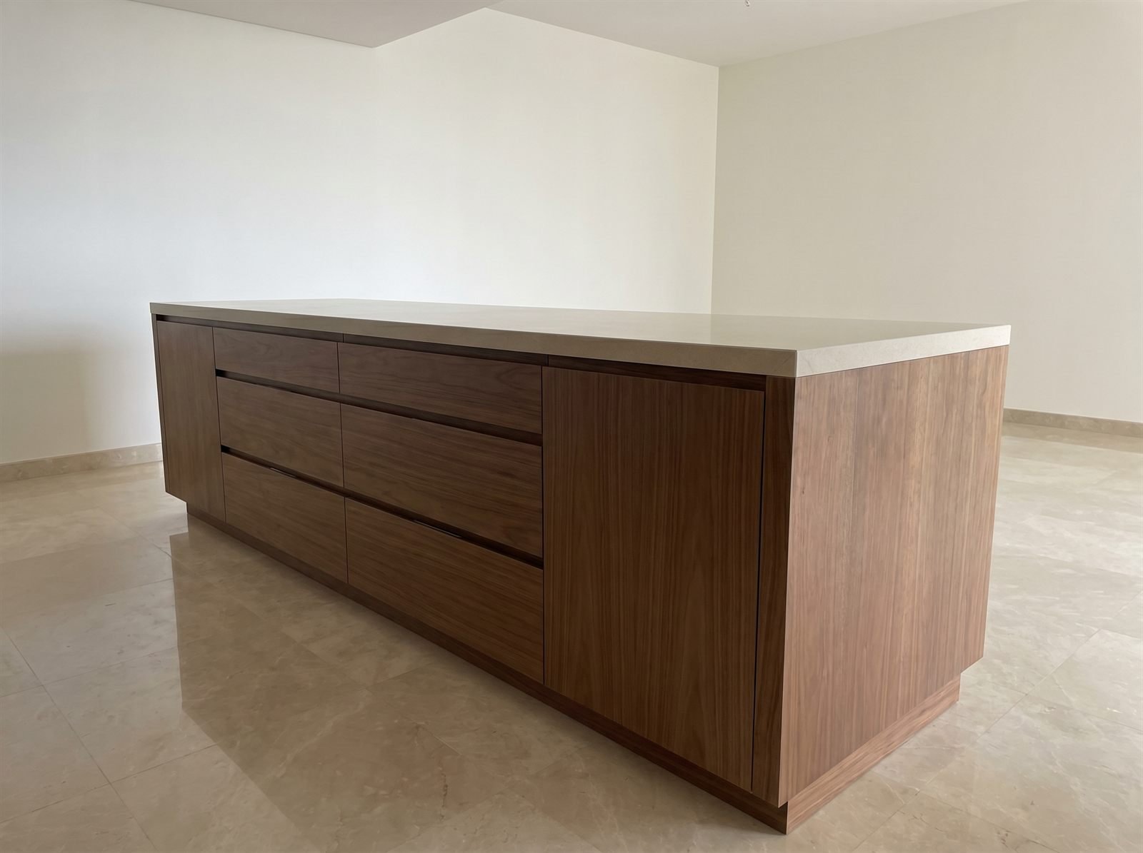 Bespoke kitchen island with cabinetry and stone top, Dubai