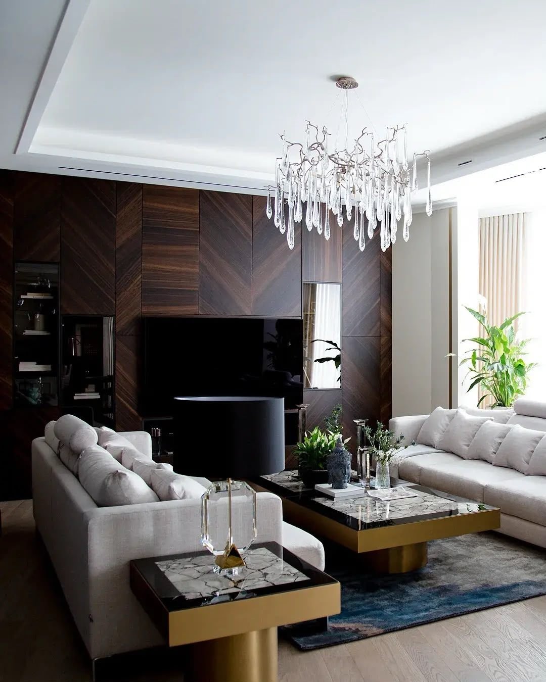 Living-room media wall in chevron walnut veneer, wide view, Dubai