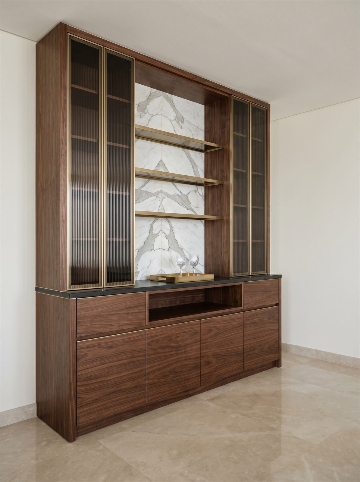 Floor-to-ceiling wine and bar display cabinet in a Dubai penthouse