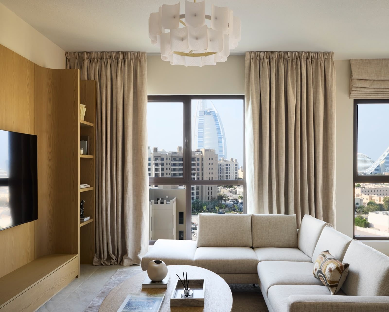 Oak media wall in a neutral living room, Dubai