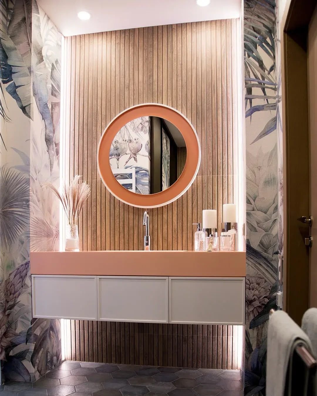 Powder room with vertical timber slat wall and peach solid-surface basin, Dubai
