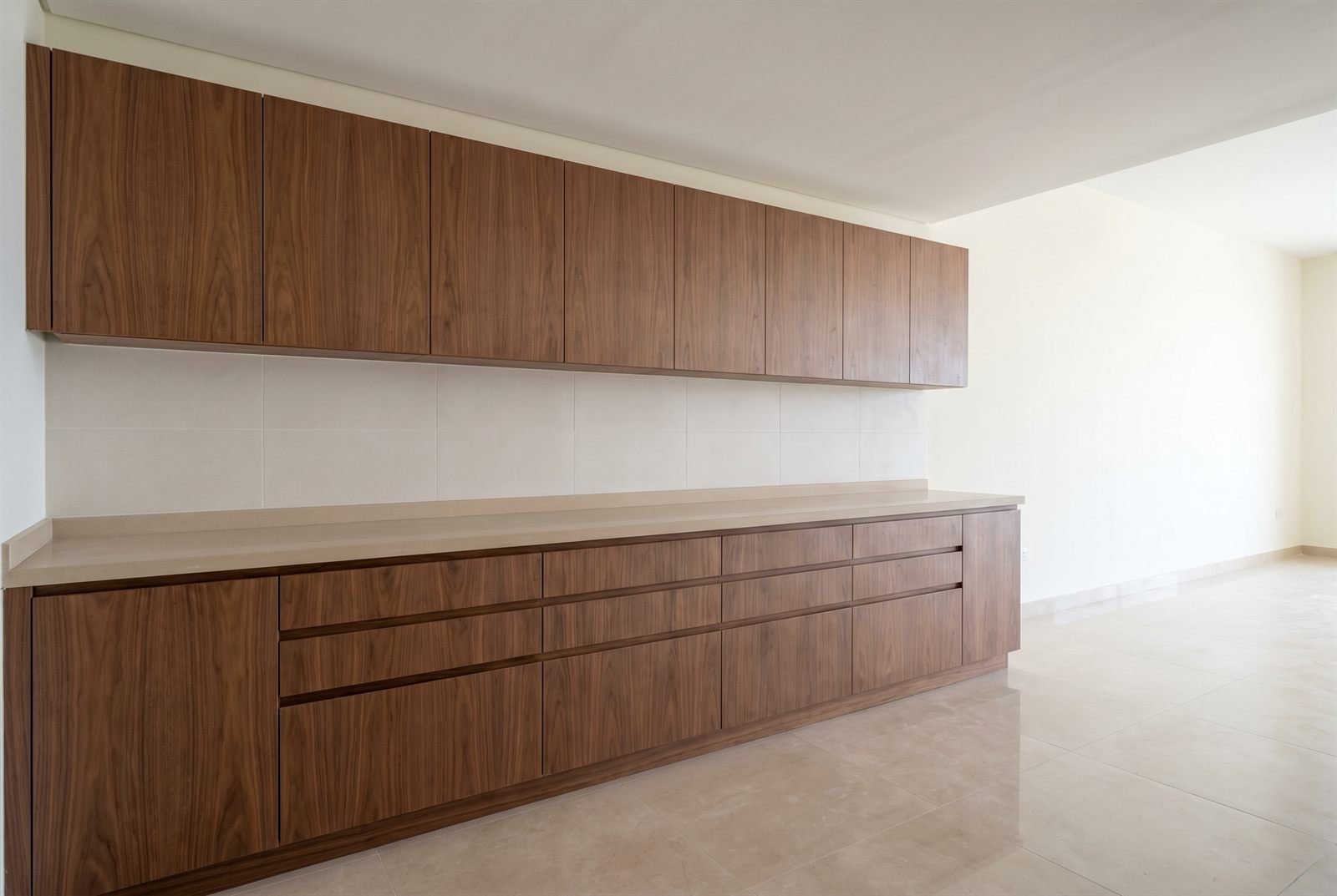 Single fitted kitchen cabinet run in a modern Dubai apartment